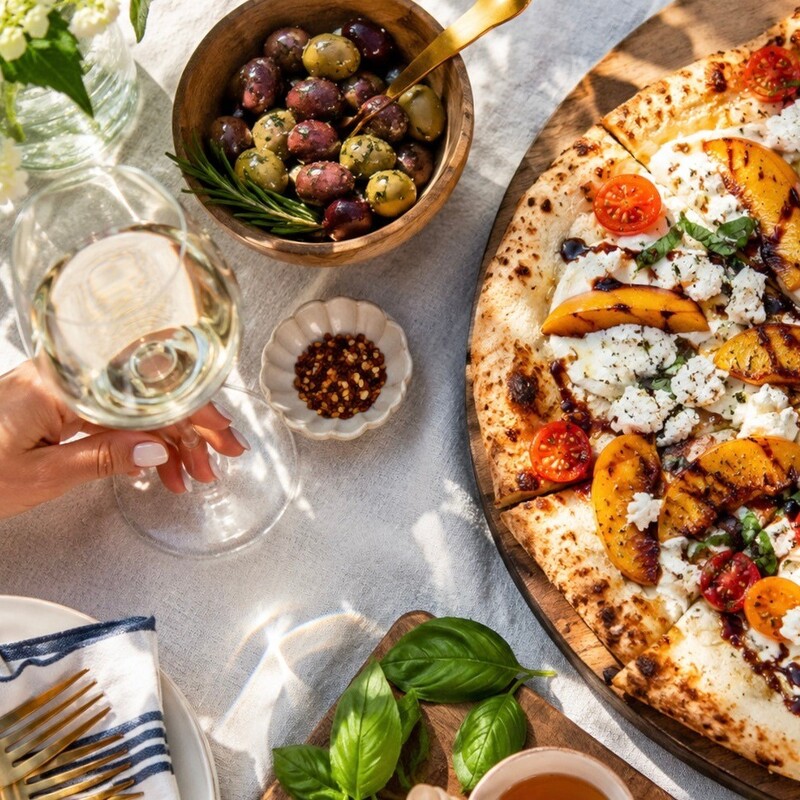 Peach, tomato & goat cheese pizza is summer on a slice