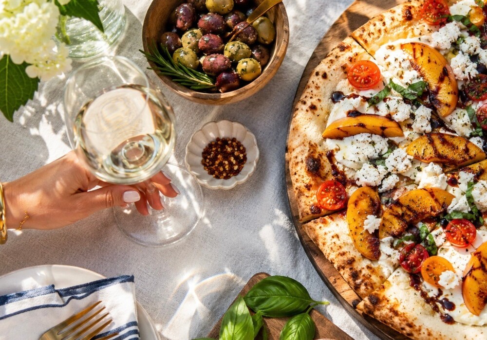 Peach, tomato & goat cheese pizza is summer on a slice